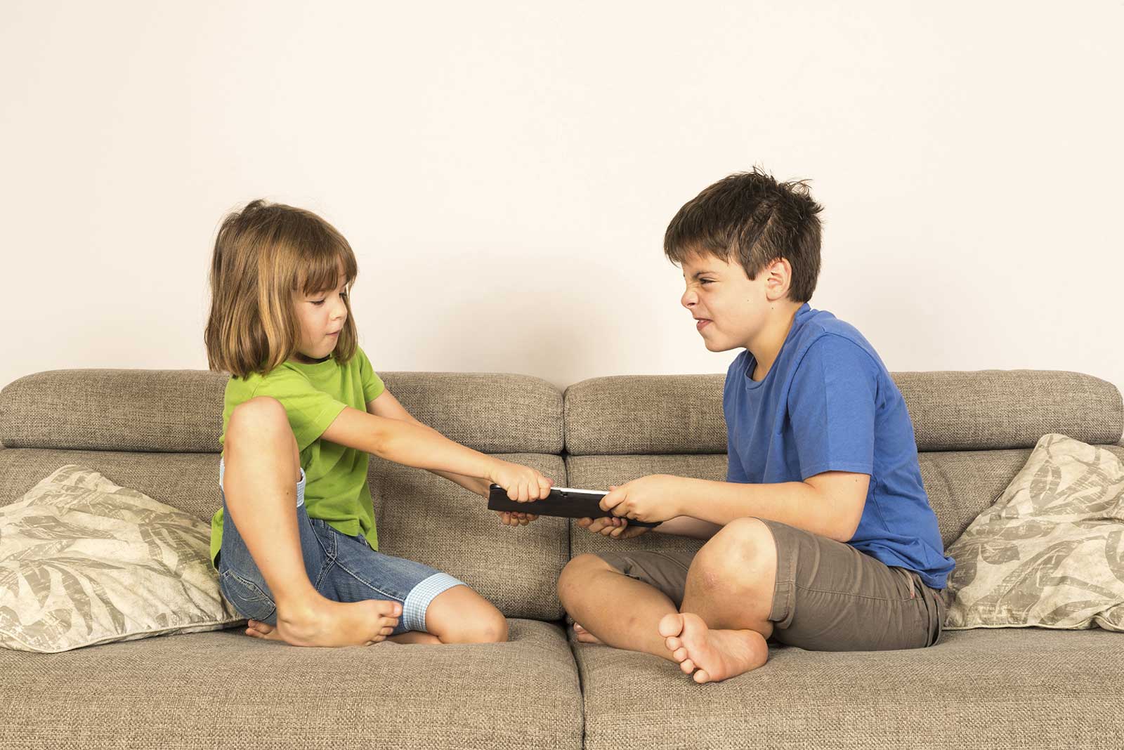Children on couch with remote